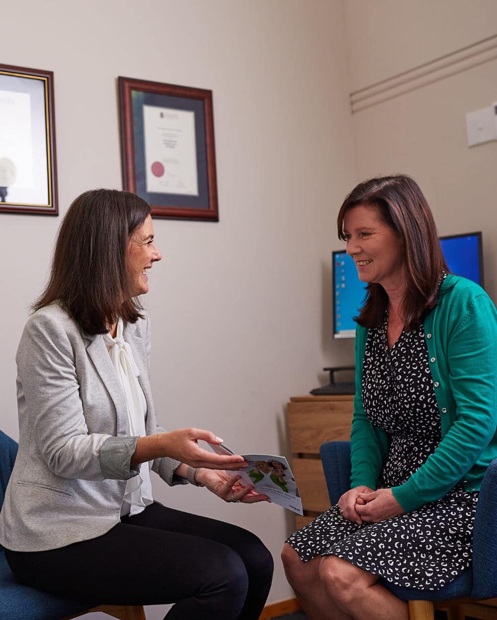 Audiologist Annie shows patient hearing aids