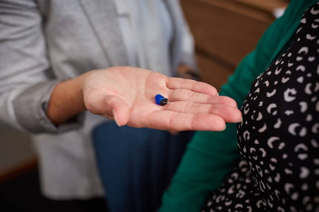 Hearing aid on open hand